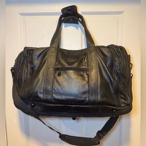 Pre-Loved Men Vintage TUMi Black Leather duffle bag, specifically from the Alpa